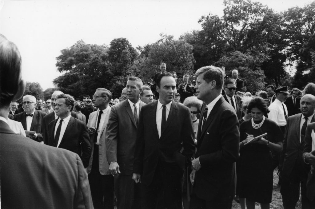 August 9, 1962--Six hundred and three Peace Corps trainees preparing in Washington area for overseas assignments visited President Kennedy on the south lawn of the White House. The President welcomed the trainees with special pleasure because they had "committed themselves to a great adventure." He repeated his hope that Peace Corps Volunteers would return to careers of service in the Government. After informal conversation with the trainees, the President on the spur of the moment ordered a special tour of the White House for the trainees. Here Kennedy talks with Harris Wofford, Special Peace Corps Representative for Africa.